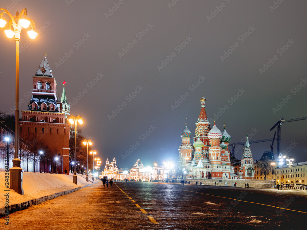 Fototapeta premium Famous landmarks - St. Basil Cathedral on Red square in Kremlin. Winter evening in Moscow, Russia.