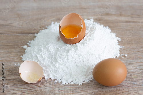eggs and flour on wooden table