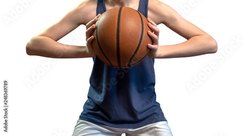 Basketball. A teenager in a blue sleeveless T-shirt holds the ball with both hands at chest level. Close-up. Isolate on white background. © romsvetnik