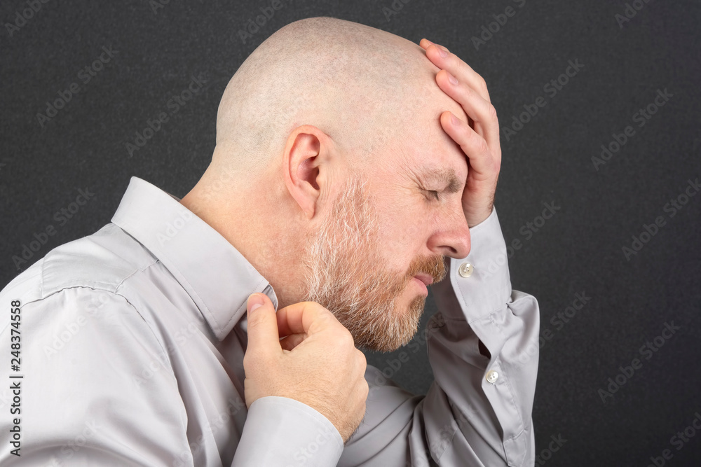man in the shirt thinks holding his hands behind his head man in the shirt thinks holding his hands behind his head