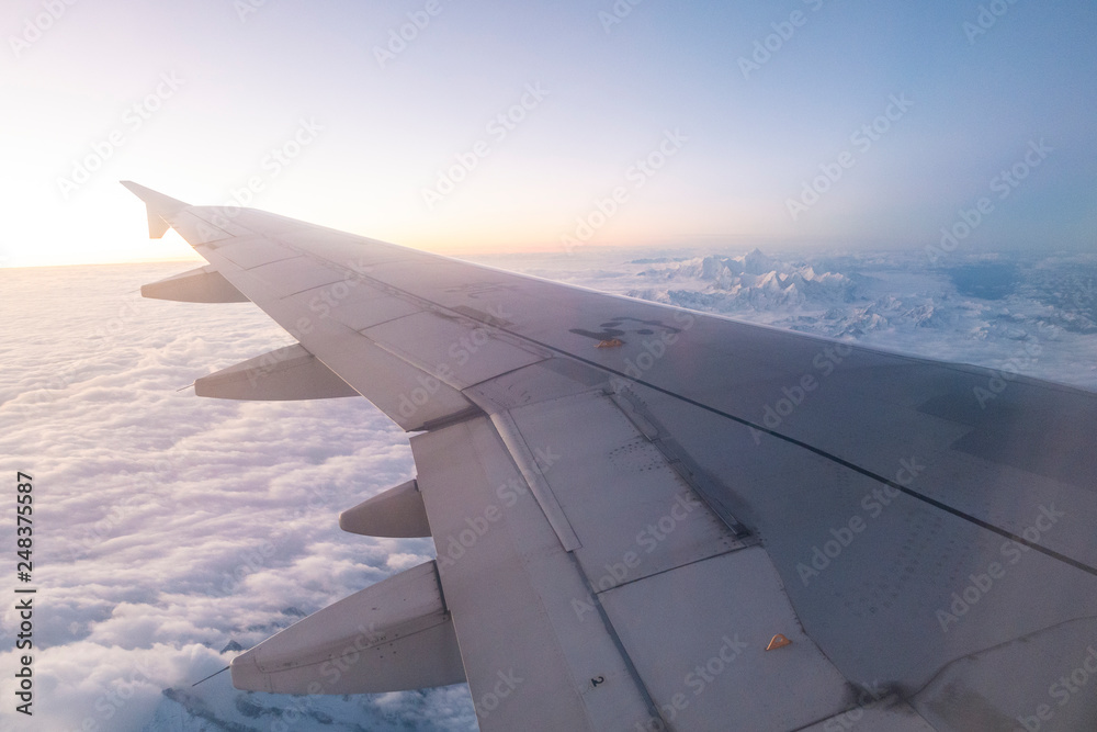 Morning light from window of airplane wing Morning light from window of airplane wing
