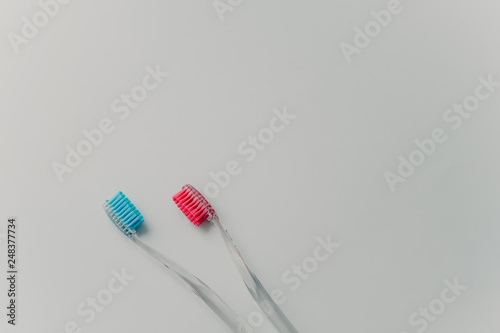 Personal hygiene and healthy teeth concept. Two multicoloured toothbrushes isolated over white background. Bathroom accessories