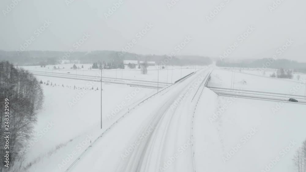 22479_The_aerial_shot_of_the_road_filled_with_white_snow.mov