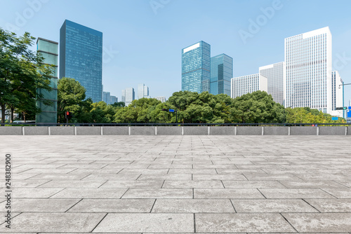 Empty Plaza floor tiles and the skyline of modern urban buildings in Hangzhou..