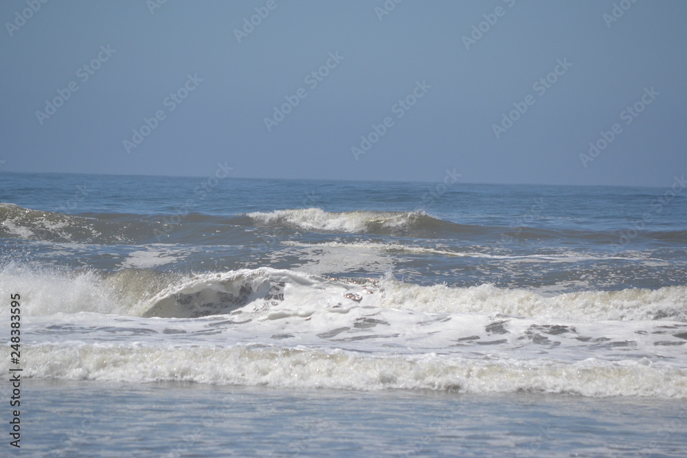 waves breaking on beach waves breaking on beach