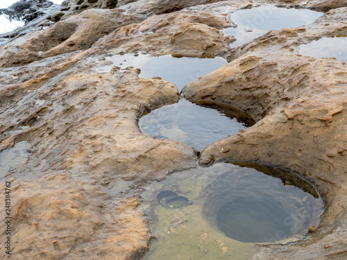 Ocean Erosion Pothole at Yehliu Geopark in Taiwan. Ocean erosion pothole is formed as a result of seawater erosion as well as weathering imposed on the notches.  photo