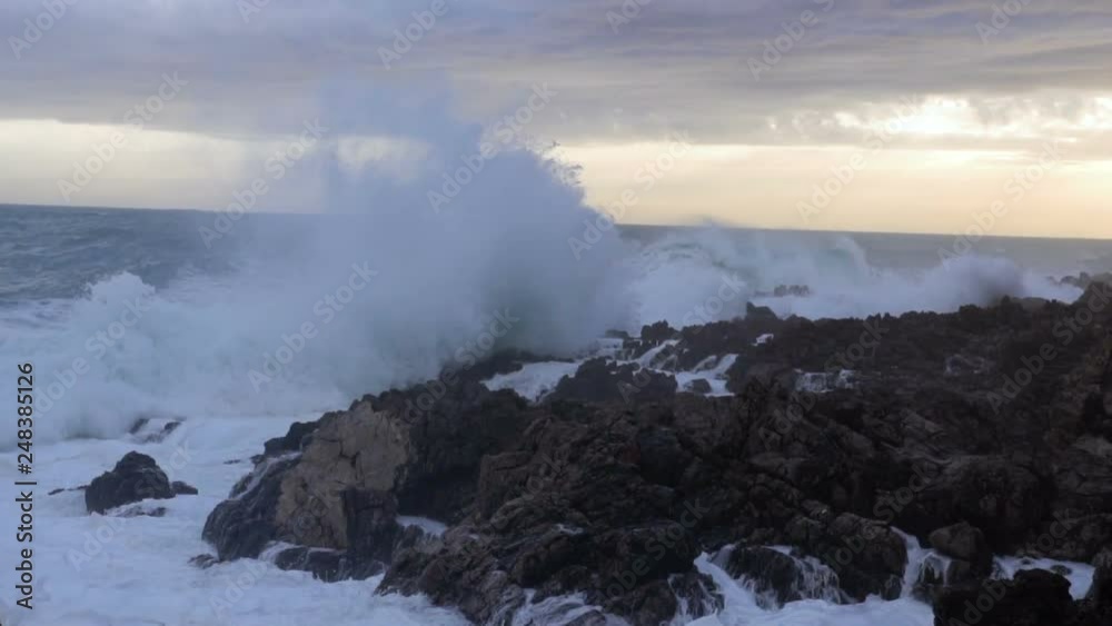Huge waves break on the stones, slow motion Huge waves break on the stones, slow motion