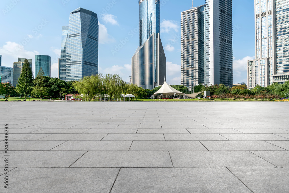 Empty square floor tiles and skyline of modern urban buildings in Shanghai..