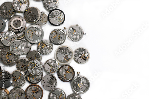 Details of clocks and mechanisms for repair, restoration and maintenance on a white background.