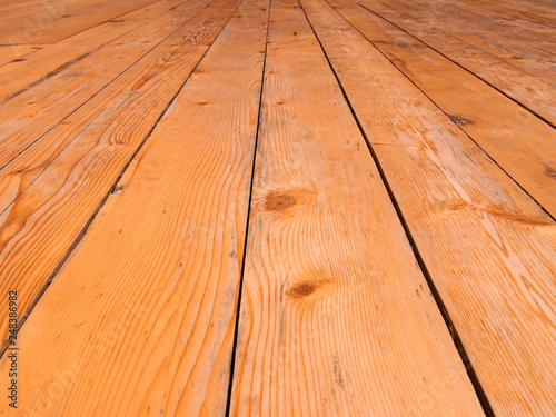 a full frame perspective view of old worn timber planking with a grainy textured surface used for flooring