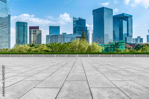 Empty square floor tiles and skyline of modern urban buildings in Shanghai..