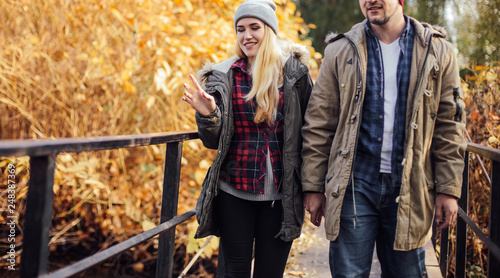 Two young travel couple walking on bridge