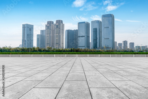 Empty Plaza floor tiles and the skyline of modern urban buildings in Hangzhou.. © 昊 周