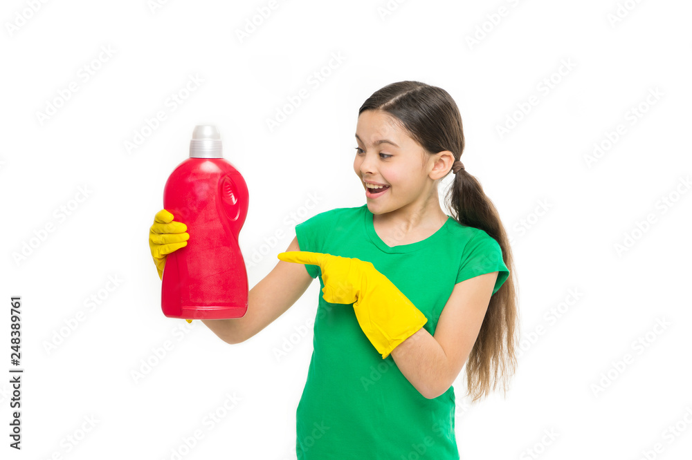 Using household cleaning product. Small housekeeper pointing at detergent bottle. Little child enjoy doing laundry. Cute household helper wearing rubber gloves. Keeping the clothes clean and fresh