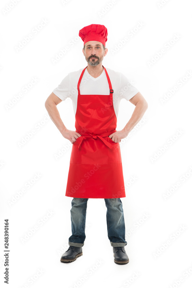 Housework includes cooking and cleaning. Bearded mature man in chef hat and apron. Senior cook with beard and moustache wearing bib apron. Mature chief cook in red cooking apron. Home cooking