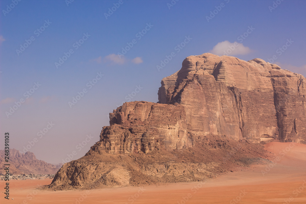 Middle East steep picturesque rock mountain yellow scenic landscape in Wadi Rum desert  