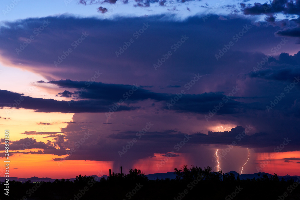 Fototapeta premium Thunderstorm cloud with lightning at sunset