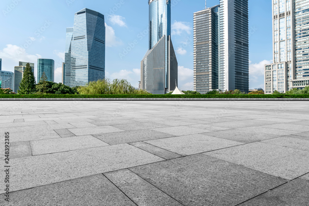 Empty square floor tiles and skyline of modern urban buildings in Shanghai..