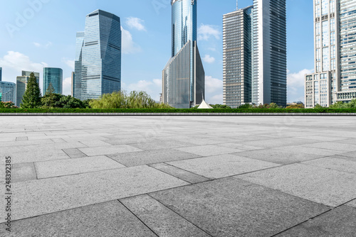 Empty square floor tiles and skyline of modern urban buildings in Shanghai..