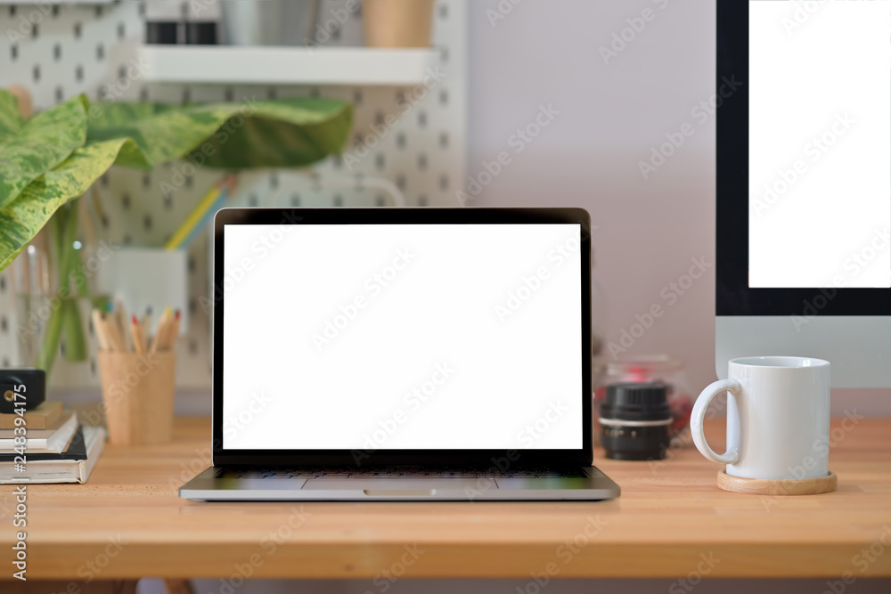 Loft wood office desk table with laptop, poster, coffee mug and supplies. Loft wood office desk table with laptop, poster, coffee mug and supplies.