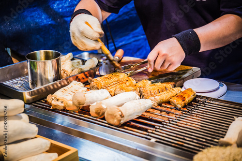 A food stalls selling grilled king oyster mushrooms on sticks at the Fengjia night market, Taiwan.
