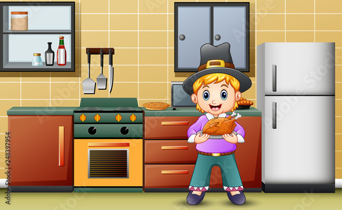 Cute boy holding a roasted in the kitchen