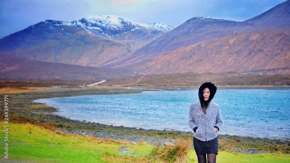 Asian woman with beautiful view of  mountains and river in Highland,Scotland, United kingdom
