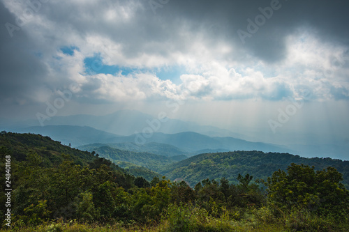 The beautiful scenery of tropical forest at Southeast Asia with mountain and cloudy background