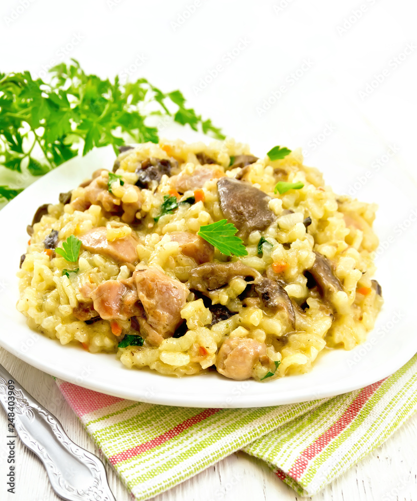Risotto with mushrooms and chicken on towel Risotto with mushrooms and chicken on towel