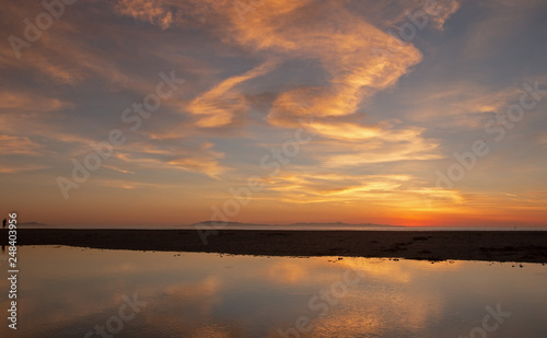 Sunset cloud reflection over Santa Clara river seaside marsh at Ventura beach in California United States