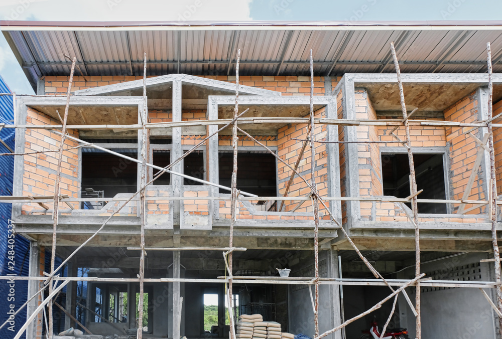 Two storey houses with wood scaffolding are under construction in Thailand, modern house design