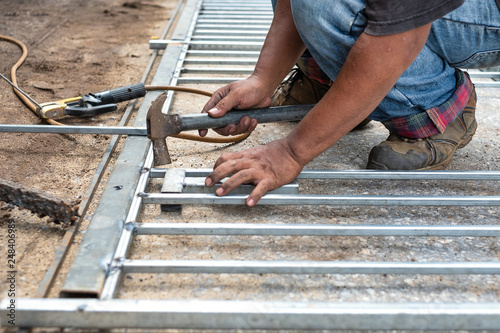 Welder use hammer adjust steel before welding, welding steel.