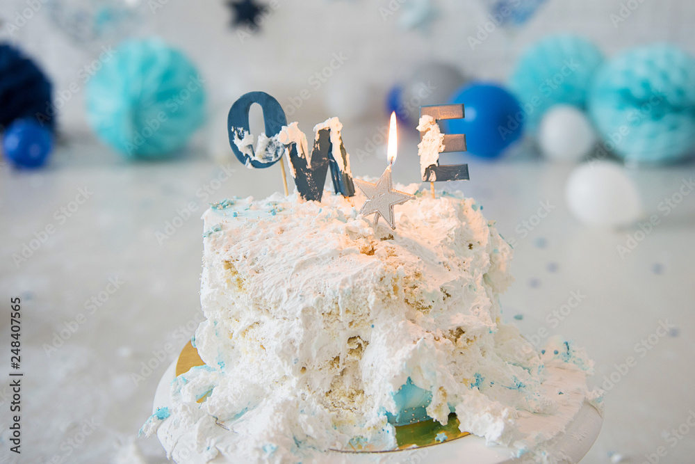 Smashed first birthday cake. Smash cake. One year. Blue colour. Messy  pieces. Birthday cake with candle. Stock Photo | Adobe Stock