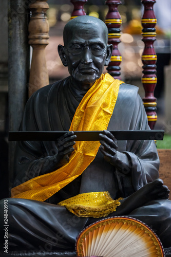 Sculpture of the old Buddhist monk. photo