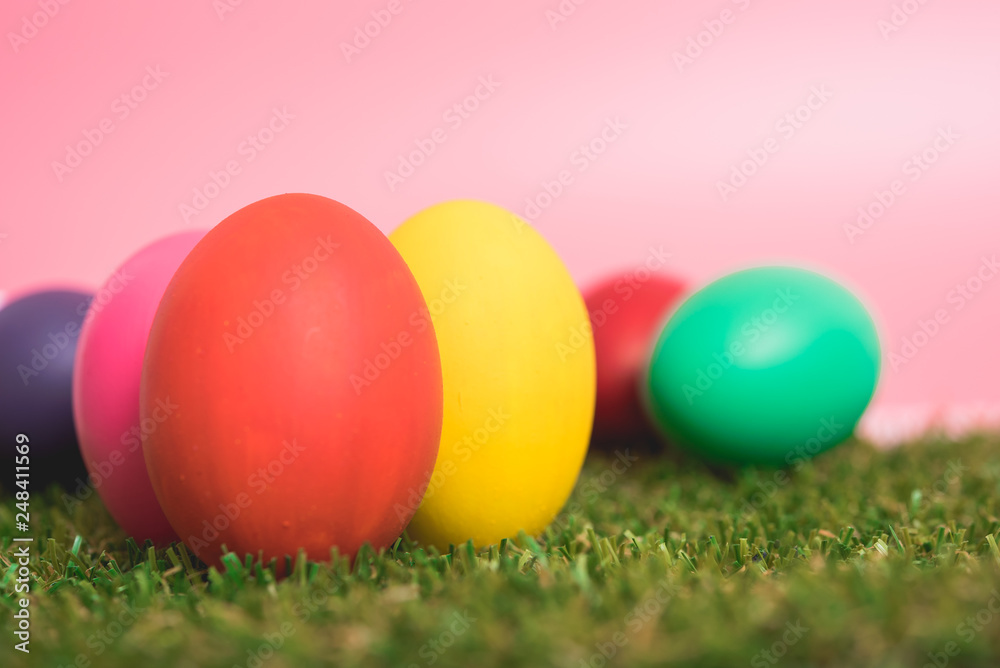 Colorful Easter eggs clean on grass and pink background Colorful Easter eggs clean on grass and pink background