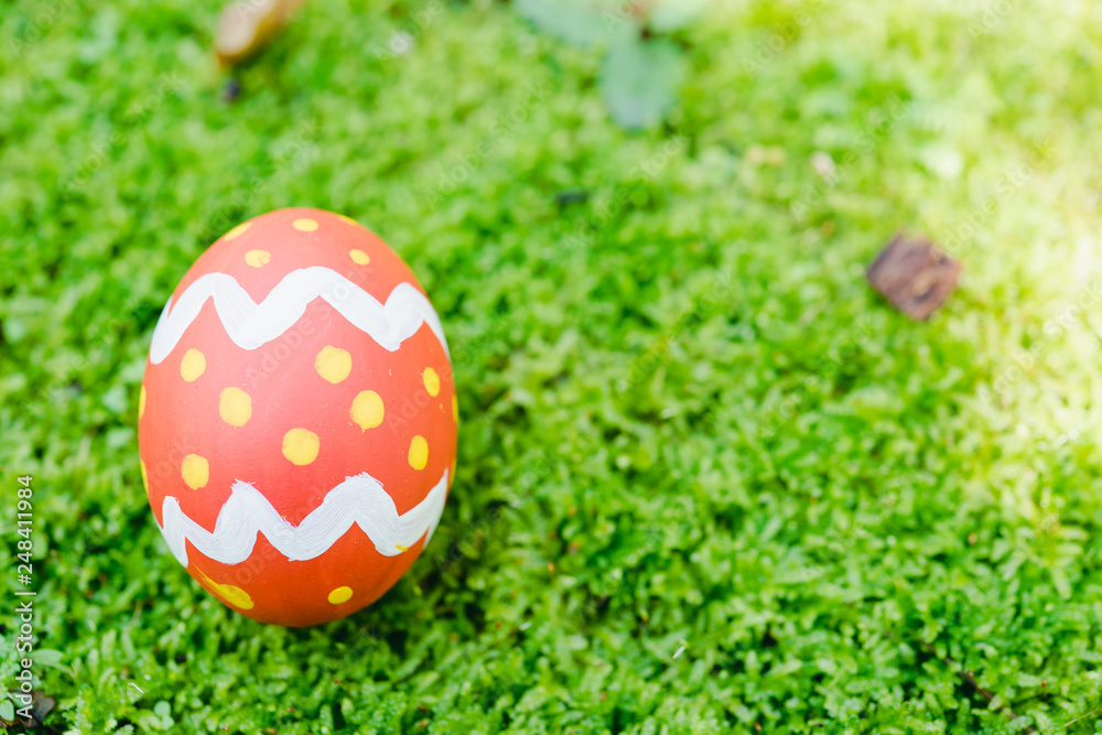 Beautiful Easter Red color egg on garden green grass Beautiful Easter Red color egg on garden green grass