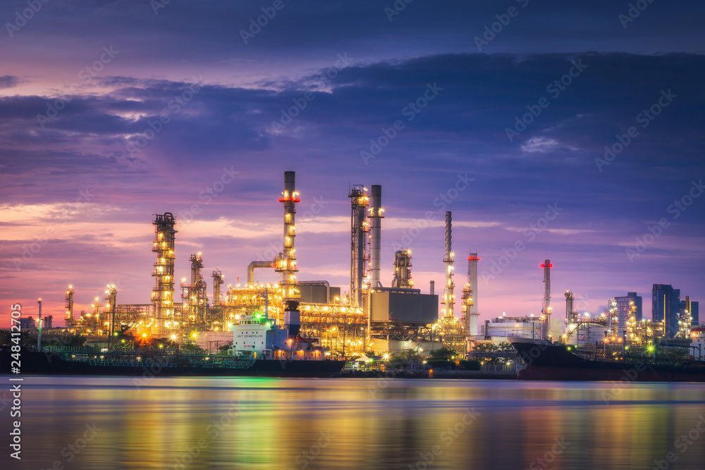 Landscape of oil and gas refinery manufacturing plant., Petrochemical or chemical distillation process buildings., Factory of power and energy industrial at twilight sunset., Engineering petroleum.