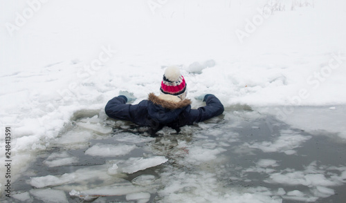 girl winter fell under the ice of the river, the threat of life frostbite photo