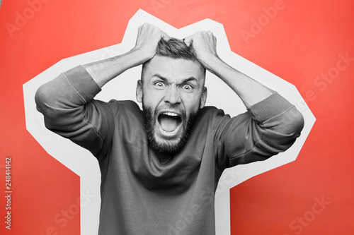 Portrait of aggressive man on color background photo