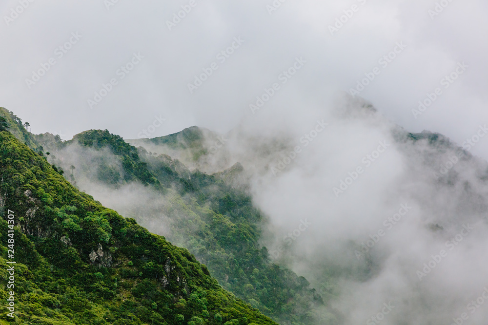 Mountain ridges covered by clouds and fog on top of Cangshan Mountains in Dali, Yunnan, China