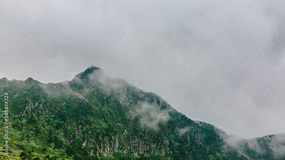 Mountain ridges covered by clouds and fog on top of Cangshan Mountains in Dali, Yunnan, China