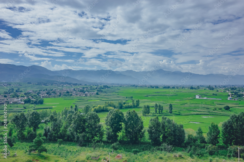 Fields and mountains under sky and clouds in Dali, Yunnan, China