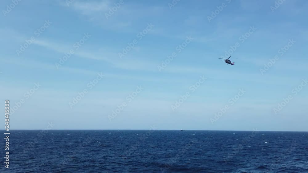 Helicopter service for oil and gas flying in the blue sky Helicopter service for oil and gas flying in the blue sky