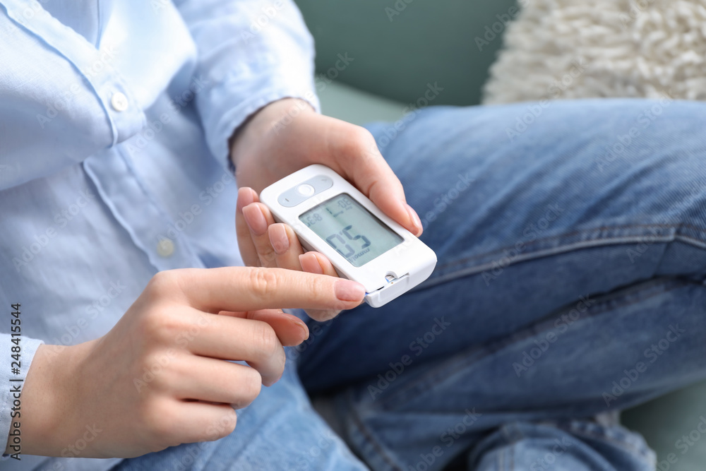 Diabetic woman using digital glucometer, closeup Diabetic woman using digital glucometer, closeup