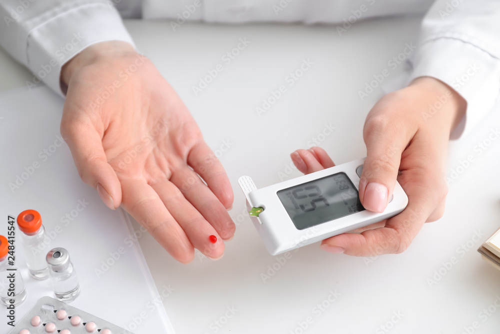 Diabetic woman using digital glucometer, closeup Diabetic woman using digital glucometer, closeup