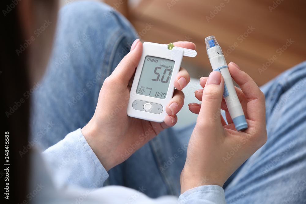 Diabetic woman using digital glucometer, closeup Diabetic woman using digital glucometer, closeup
