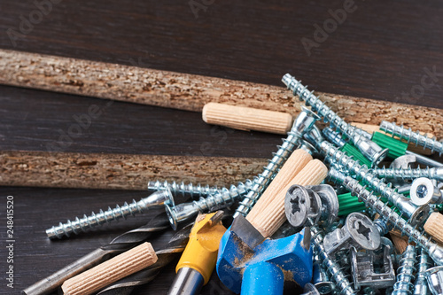 Tools for furniture assembly on a wooden background closeup