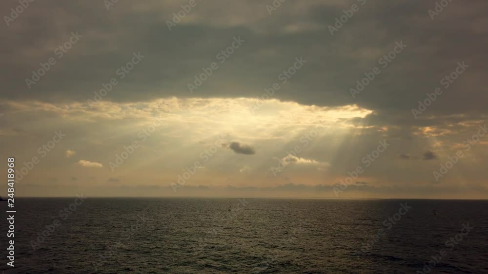 Light passing through clouds. Ray of light in the middle of the ocean. Light passing through clouds. Ray of light in the middle of the ocean.