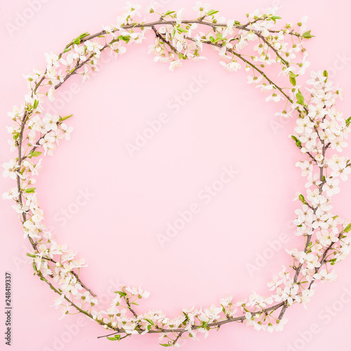 Floral frame with spring flowers on pastel background. Flat lay, top view. Spring time background.