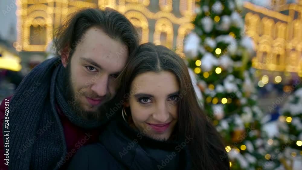 Beautiful brunet couple in love posing outdoor during christmas holidays. Beautiful brunet couple in love posing outdoor during christmas holidays.
